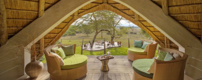 The upstairs guest area at Solio Lodge overlooks the outdoor dining area, and the conservancy beyond.