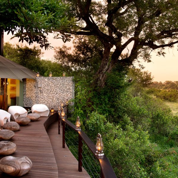 Comfortable egg chairs invite lazy afternoons watching wildlife right from the guest deck at Ngala Tented Camp.
