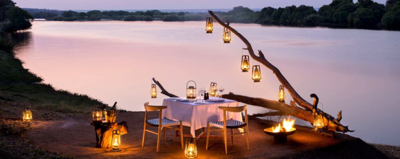 Enjoy private riverside dining at Matetsi River Lodge.