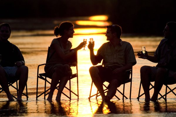 You’ll toast to a good day every day of your Zambia walking safari. © Robin Pope Safaris